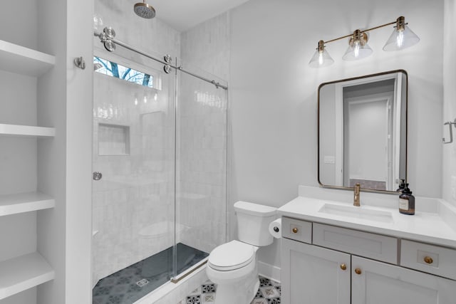 bathroom featuring toilet, vanity, and walk in shower