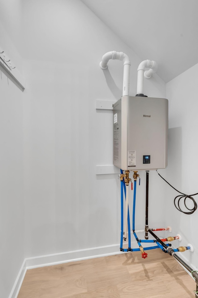 utility room featuring tankless water heater