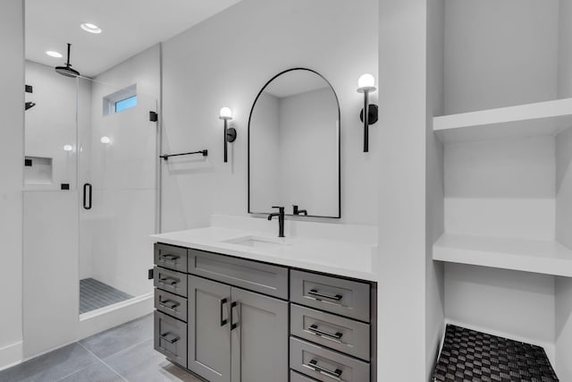 bathroom featuring vanity, tile patterned floors, and a shower with shower door