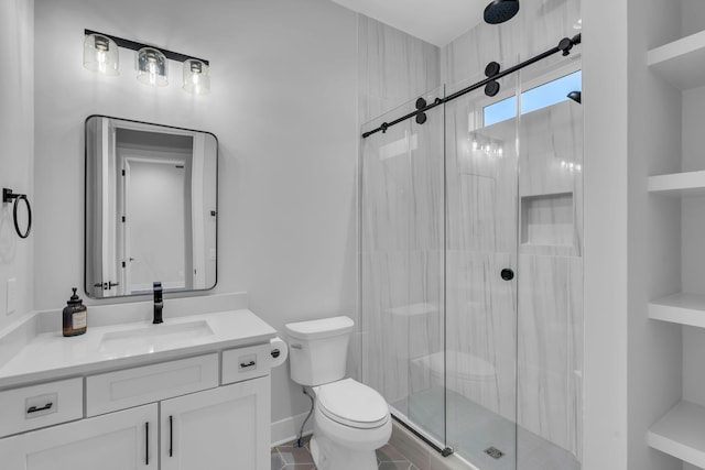 bathroom featuring built in shelves, vanity, a shower with shower door, and toilet