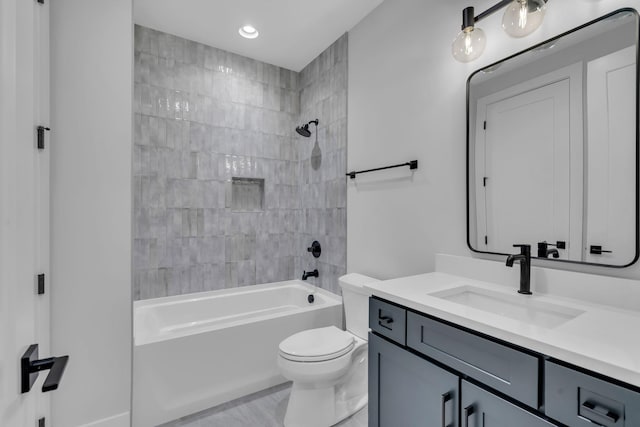 full bathroom with vanity, toilet, and tiled shower / bath