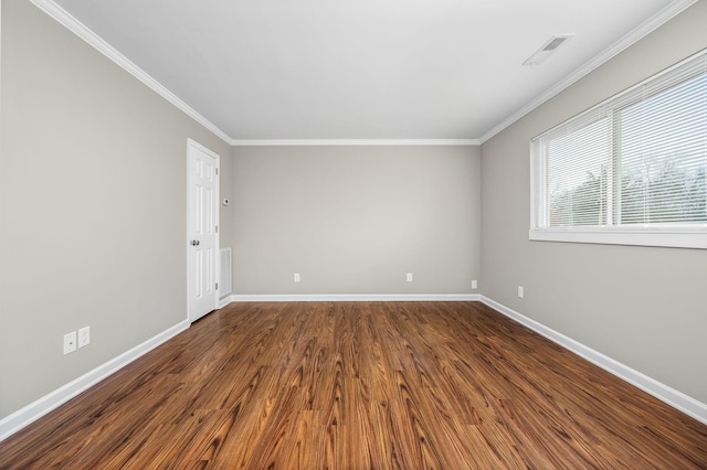 empty room featuring crown molding and dark wood-type flooring