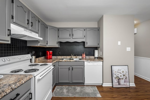 kitchen featuring dark hardwood / wood-style flooring, white appliances, gray cabinets, and sink