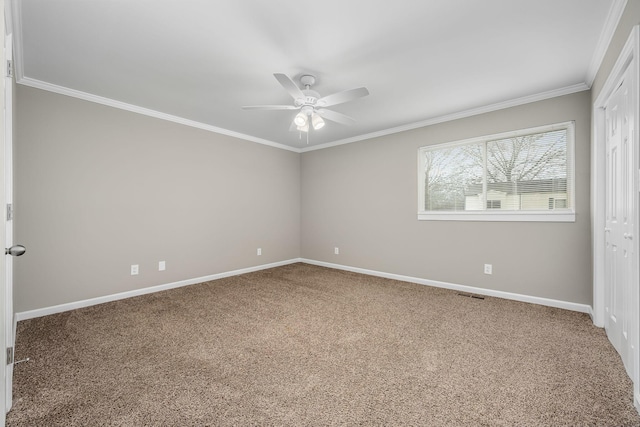 carpeted empty room with crown molding and ceiling fan