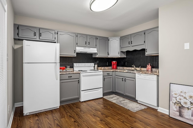 kitchen featuring decorative backsplash, white appliances, gray cabinets, and dark wood-type flooring