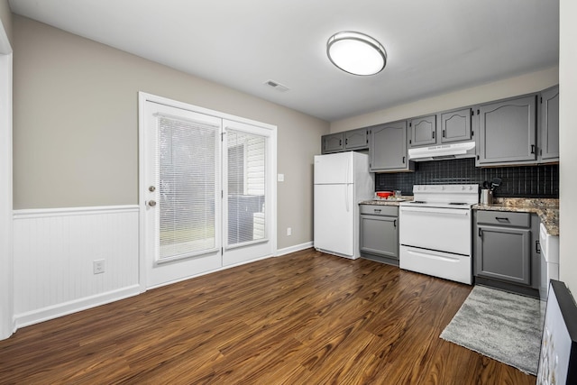 kitchen with decorative backsplash, dark hardwood / wood-style flooring, white appliances, and gray cabinetry