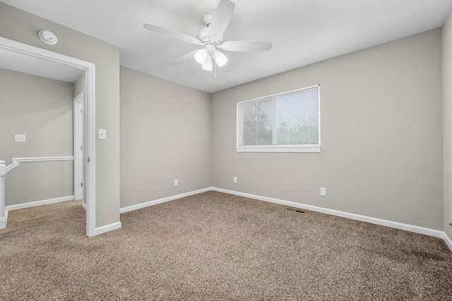 empty room with ceiling fan and carpet floors