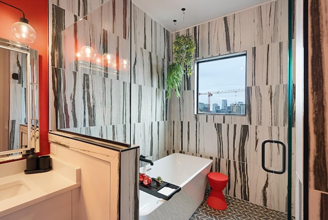 bathroom featuring vanity, shower with separate bathtub, and tile walls