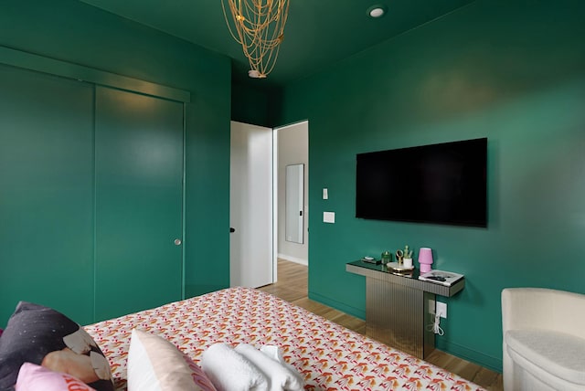 bedroom featuring hardwood / wood-style floors and a closet