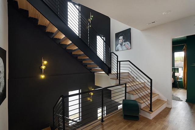 staircase with hardwood / wood-style flooring