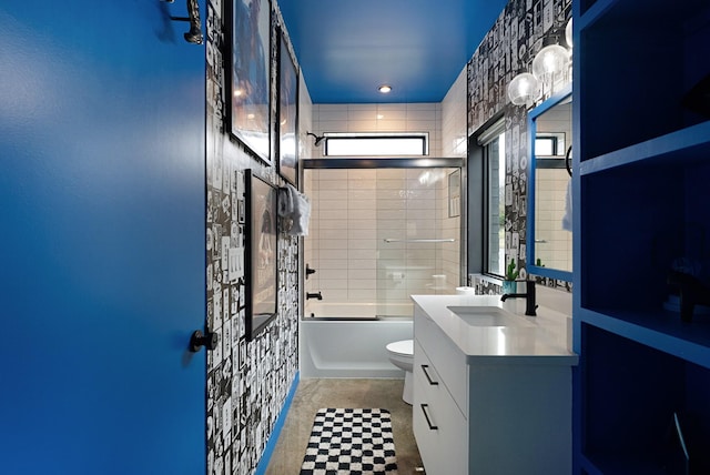 full bathroom with tile patterned flooring, combined bath / shower with glass door, toilet, vanity, and tile walls