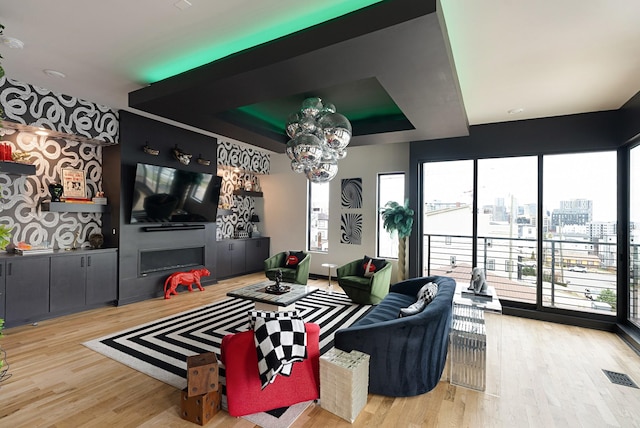 living room featuring light hardwood / wood-style floors and an inviting chandelier