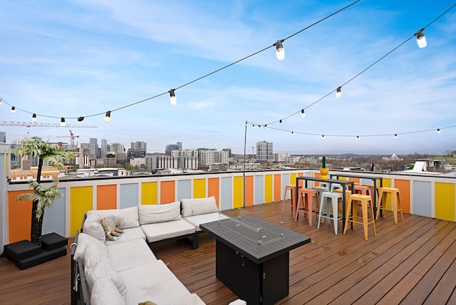 wooden terrace with an outdoor hangout area