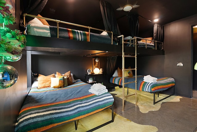 bedroom featuring concrete flooring