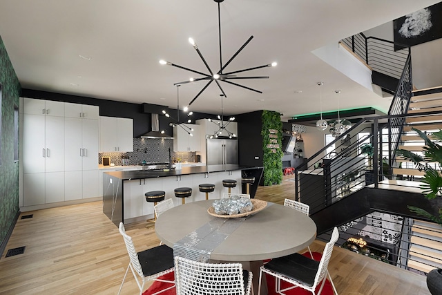 dining room featuring a chandelier and light wood-type flooring