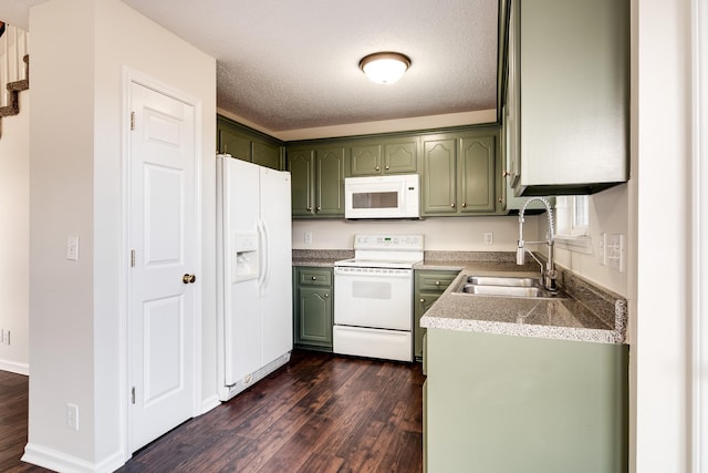 kitchen featuring sink, dark hardwood / wood-style flooring, a textured ceiling, white appliances, and green cabinetry