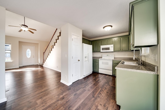 kitchen featuring a textured ceiling, white appliances, dark wood-type flooring, sink, and green cabinets