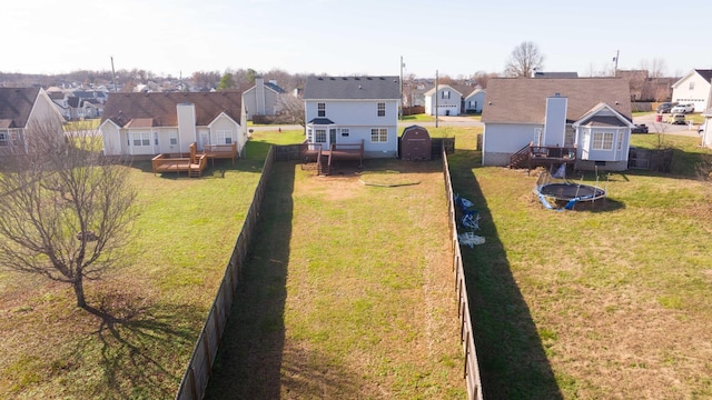 view of yard featuring a deck and a trampoline