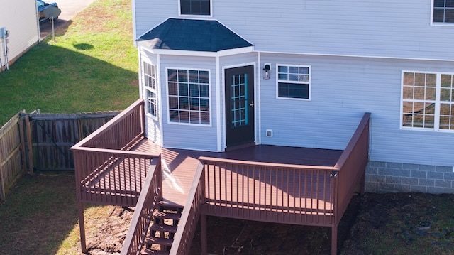 wooden terrace featuring a yard