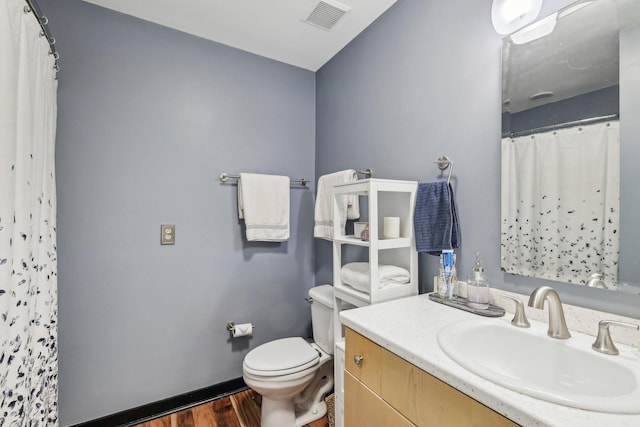 bathroom with vanity, hardwood / wood-style flooring, toilet, and curtained shower