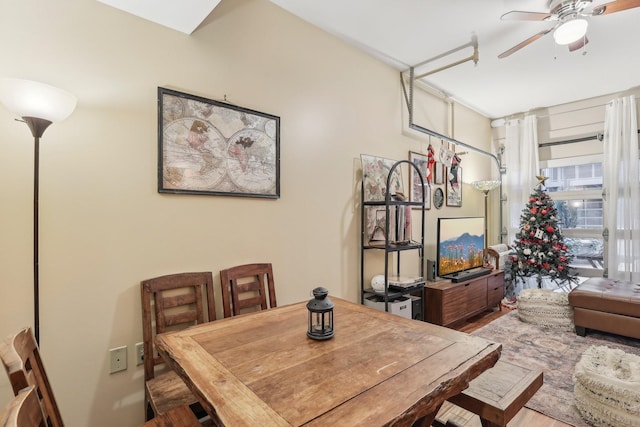 dining space with ceiling fan and hardwood / wood-style flooring