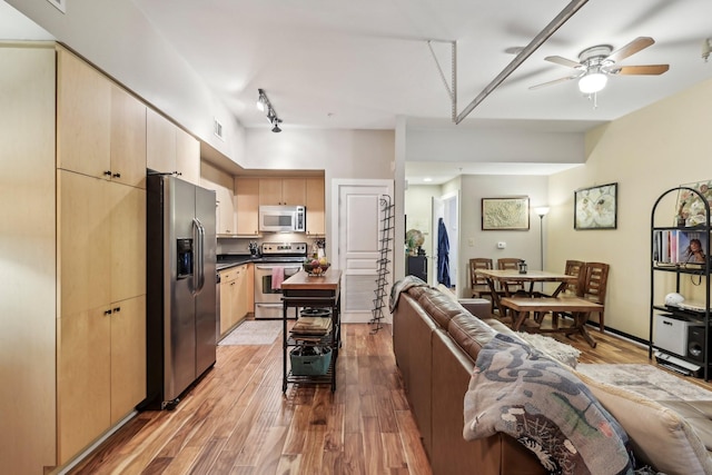 living room with ceiling fan and light wood-type flooring