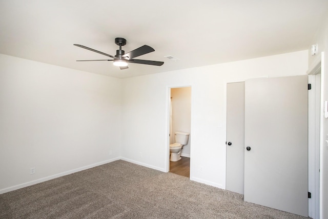 unfurnished bedroom featuring ensuite bath, ceiling fan, and carpet floors