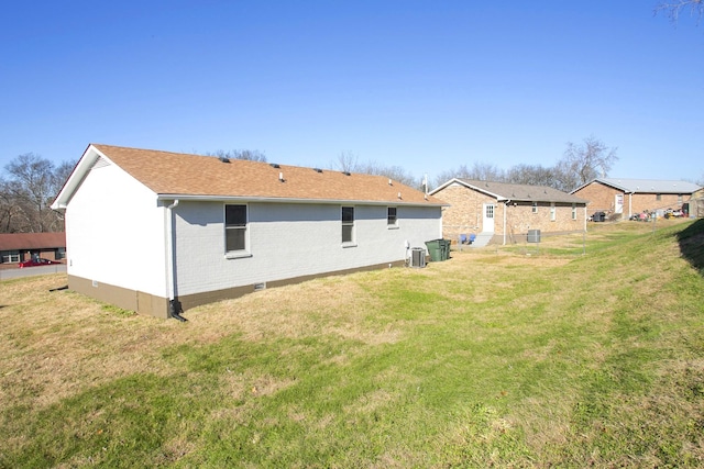 rear view of property with a yard and cooling unit