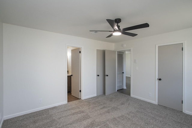 unfurnished bedroom featuring connected bathroom, ceiling fan, and light carpet