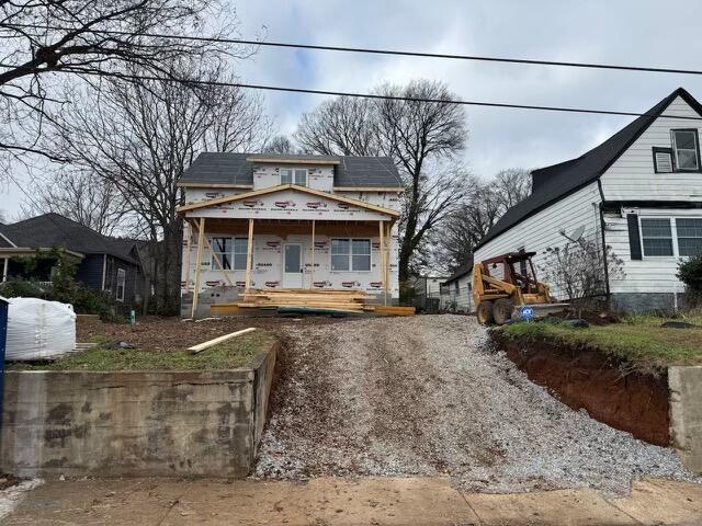 property under construction with covered porch and solar panels