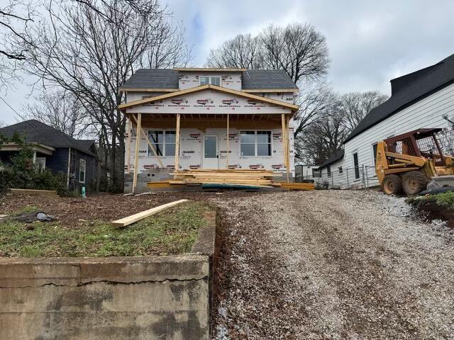 view of front of property with solar panels and covered porch