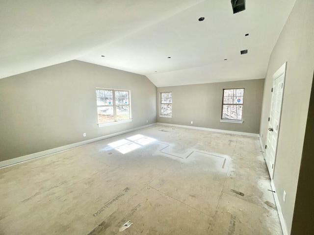 interior space with lofted ceiling and baseboards