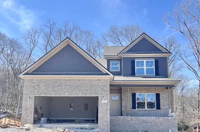 craftsman house with brick siding and an attached garage