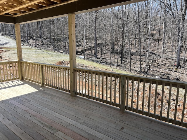 wooden deck with a forest view