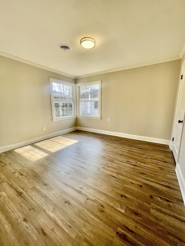 spare room featuring hardwood / wood-style floors and ornamental molding