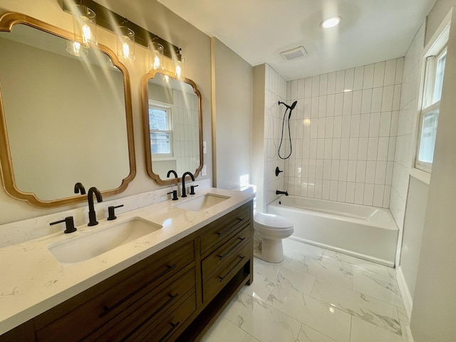 full bathroom featuring vanity, toilet, and tiled shower / bath