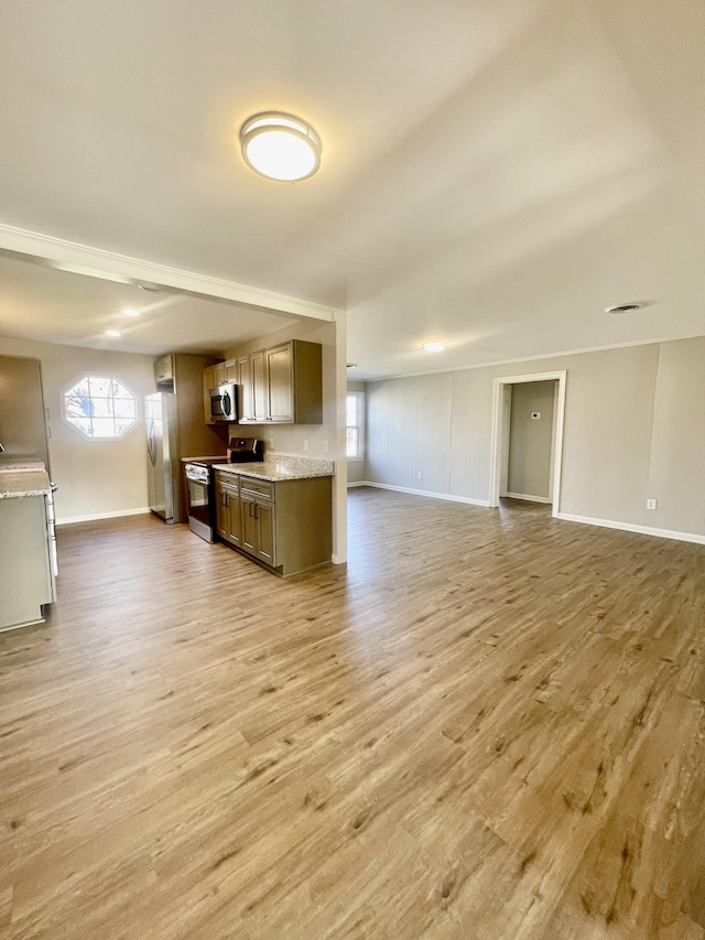 kitchen featuring light stone counters, light hardwood / wood-style floors, and appliances with stainless steel finishes