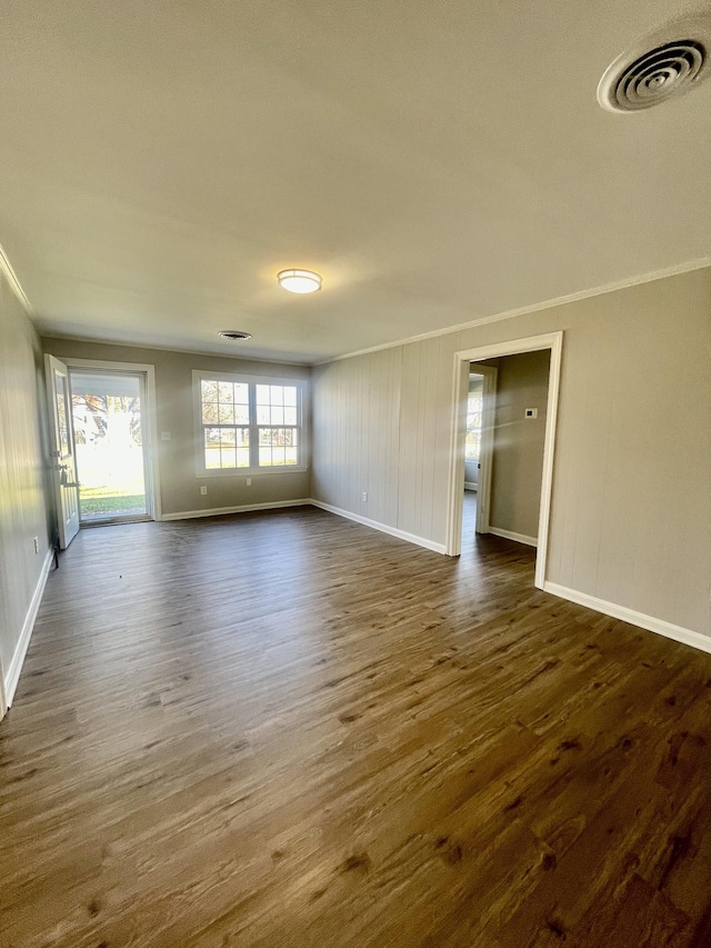 unfurnished room featuring dark hardwood / wood-style floors and crown molding