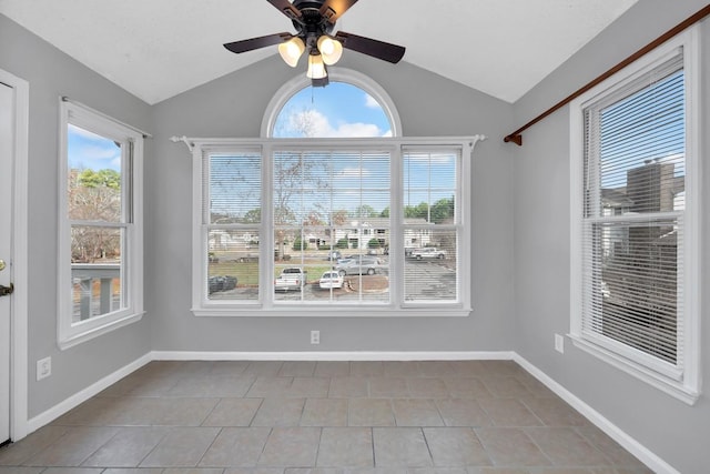 unfurnished dining area featuring light tile patterned floors, a wealth of natural light, and lofted ceiling