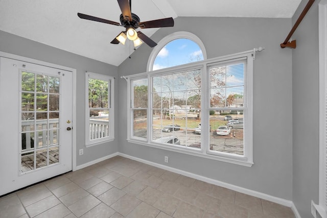 unfurnished sunroom with ceiling fan, plenty of natural light, and lofted ceiling