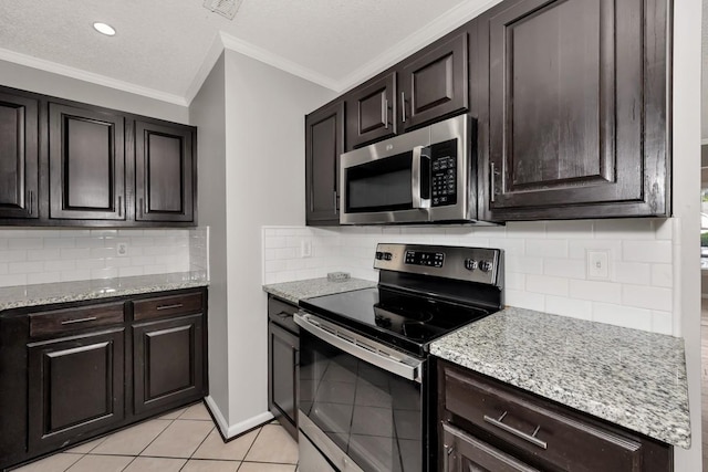 kitchen featuring backsplash, crown molding, light tile patterned floors, and stainless steel appliances