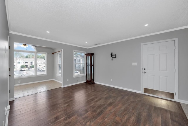 interior space featuring a textured ceiling, dark hardwood / wood-style floors, and ornamental molding