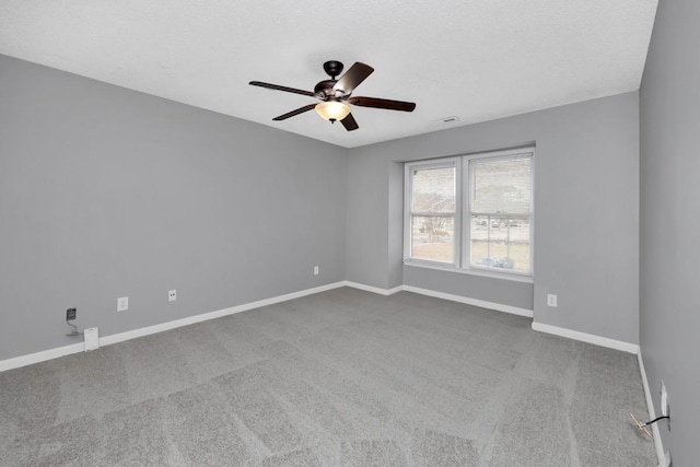 empty room with carpet, a textured ceiling, and ceiling fan