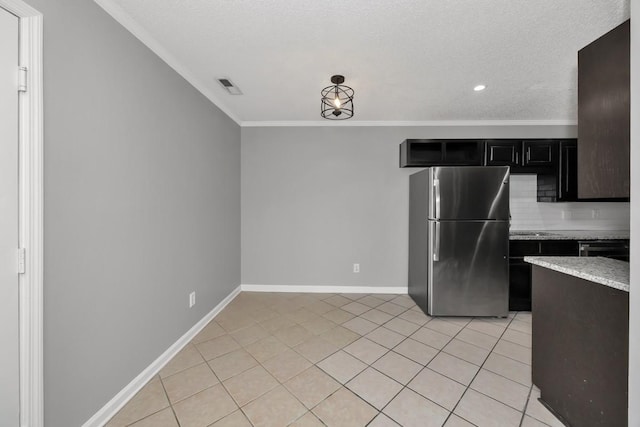 kitchen with light stone countertops, stainless steel appliances, crown molding, a textured ceiling, and light tile patterned flooring