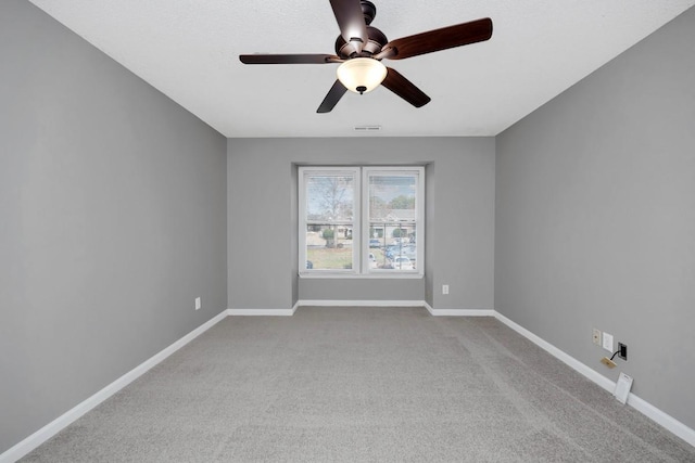 unfurnished room with ceiling fan and light colored carpet