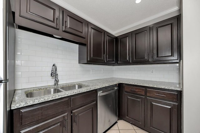 kitchen with sink, stainless steel appliances, a textured ceiling, light tile patterned floors, and ornamental molding