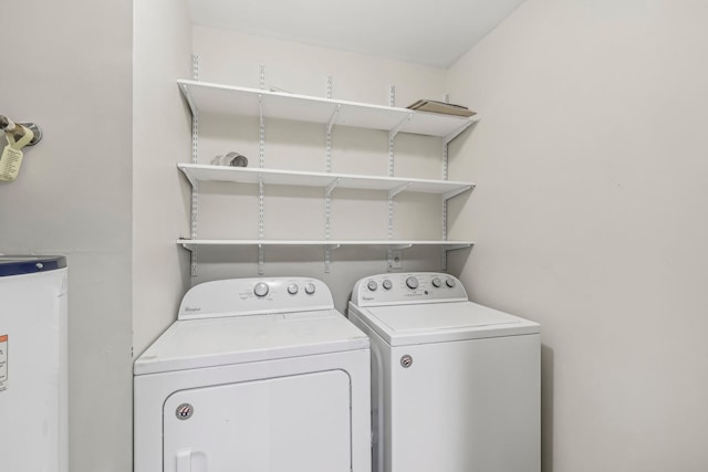 washroom featuring washing machine and dryer and water heater