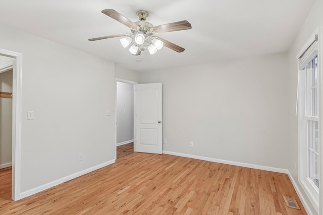 unfurnished bedroom with a closet, light hardwood / wood-style floors, and ceiling fan