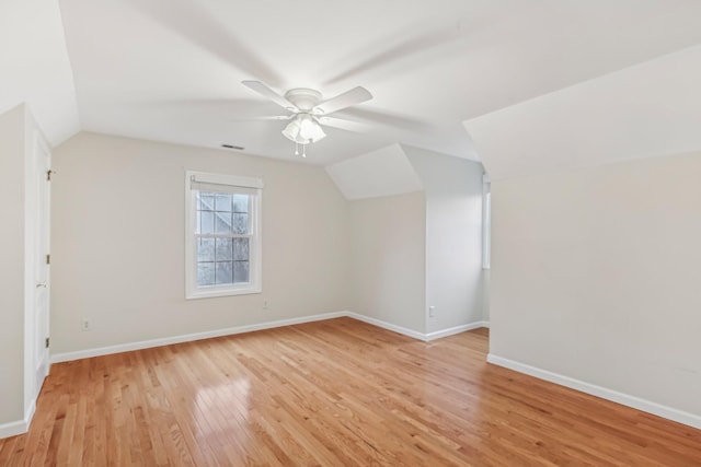 additional living space featuring ceiling fan, light hardwood / wood-style floors, and vaulted ceiling