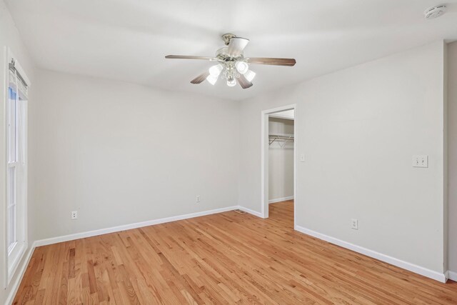 unfurnished bedroom featuring light wood-type flooring, a closet, and ceiling fan